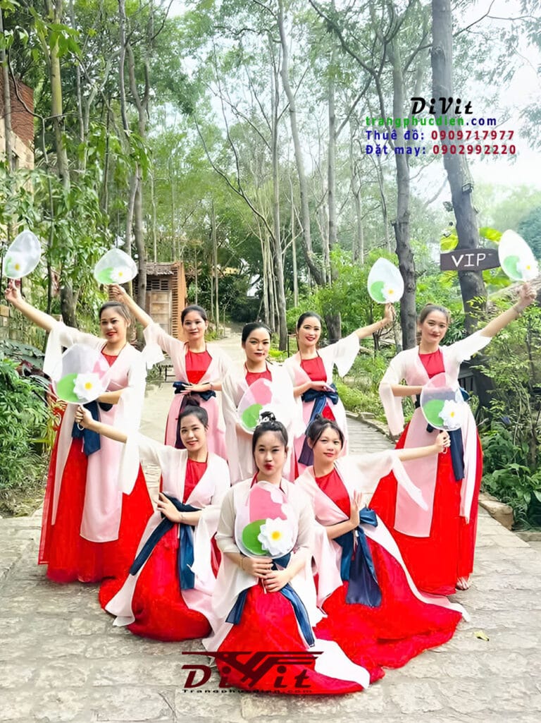 Nhóm áo dài trắng đỏ tạo dáng cùng hoa và đạo cụ ngoài trời